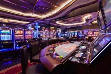 A glowing roulette wheel with cascading chips, symbolizing the engaging live and instant-win games available on 99X9.